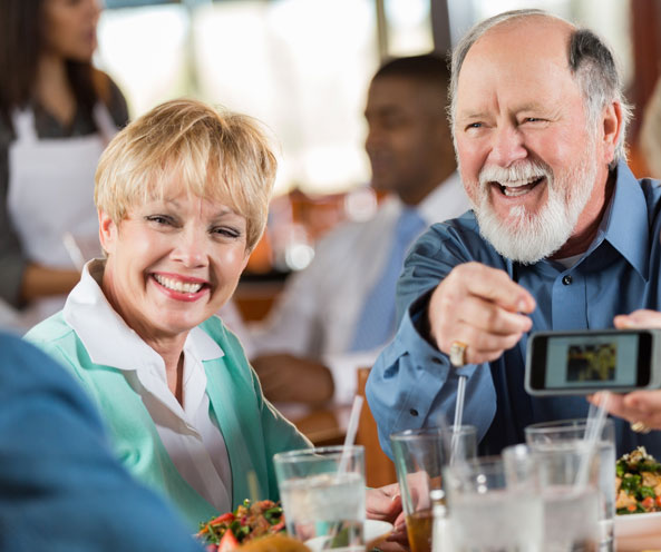 Couple laughing in community dining room.